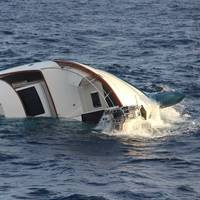 A US Coast Guard helicopter crew rescued four men from a life raft on December 15, 2019 after they were forced to abandon the 80-foot sinking yacht, Clam Chowder, approximately 25 nautical miles northwest of Aguadilla, Puerto Rico. (U.S. Coast Guard photo)