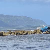 The Coast Guard, Honolulu Fire Department, and Honolulu Police Department respond to a report of a 21-foot powerboat grounded off Haleiwa Harbor, April 16, 2020. Pollution responders are on the scene assessing the situation and surrounding area for impacts. (U.S. Coast Guard photo by Petty Officer 2nd Class Laura Hadley/Released) 