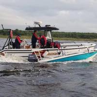 A Coast Guard Station Mayport boatcrew and good Samaritans rescue three people from the water April 23, 2018, after their vessel capsized near Blount Island in Jacksonville, Florida.(U.S. Coast Guard photo courtesy of Coast Guard Station Mayport)