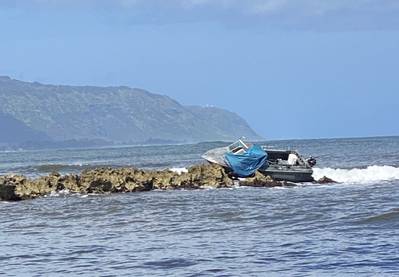 The Coast Guard, Honolulu Fire Department, and Honolulu Police Department respond to a report of a 21-foot powerboat grounded off Haleiwa Harbor, April 16, 2020. Pollution responders are on the scene assessing the situation and surrounding area for impacts. (U.S. Coast Guard photo by Petty Officer 2nd Class Laura Hadley/Released) 