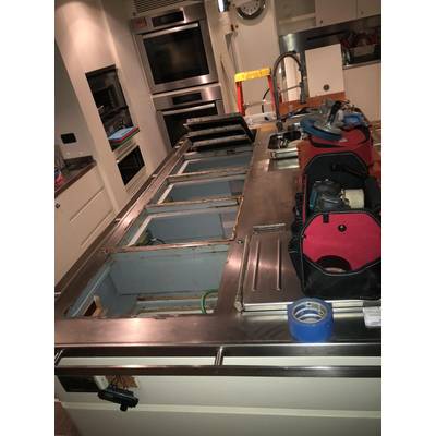 dismantling old oven in galley. Photos by Hill Robinson. 