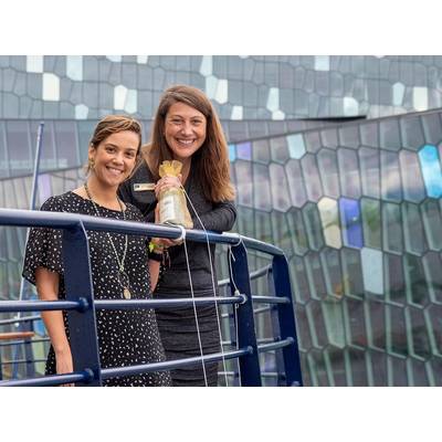 Jen Martin, Director of Field Staff & Expedition Development, and Ana Esteves, Director, Hotel Operations, toss the champagne bottle at the christening of National Geographic Endurance in Reykjavik, Iceland. 
Photo credit: Michael S. Nolan