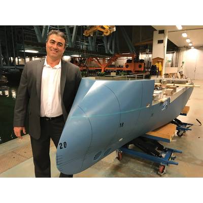 Nikolaos Doulis, Senior Vice President, New Buildings, Lindblad Expeditions, and the model of National Geographic Endurance at the tank testing facility, sporting Ulstein’s signature ‘XBow’. Photo: Lindblad Expeditions